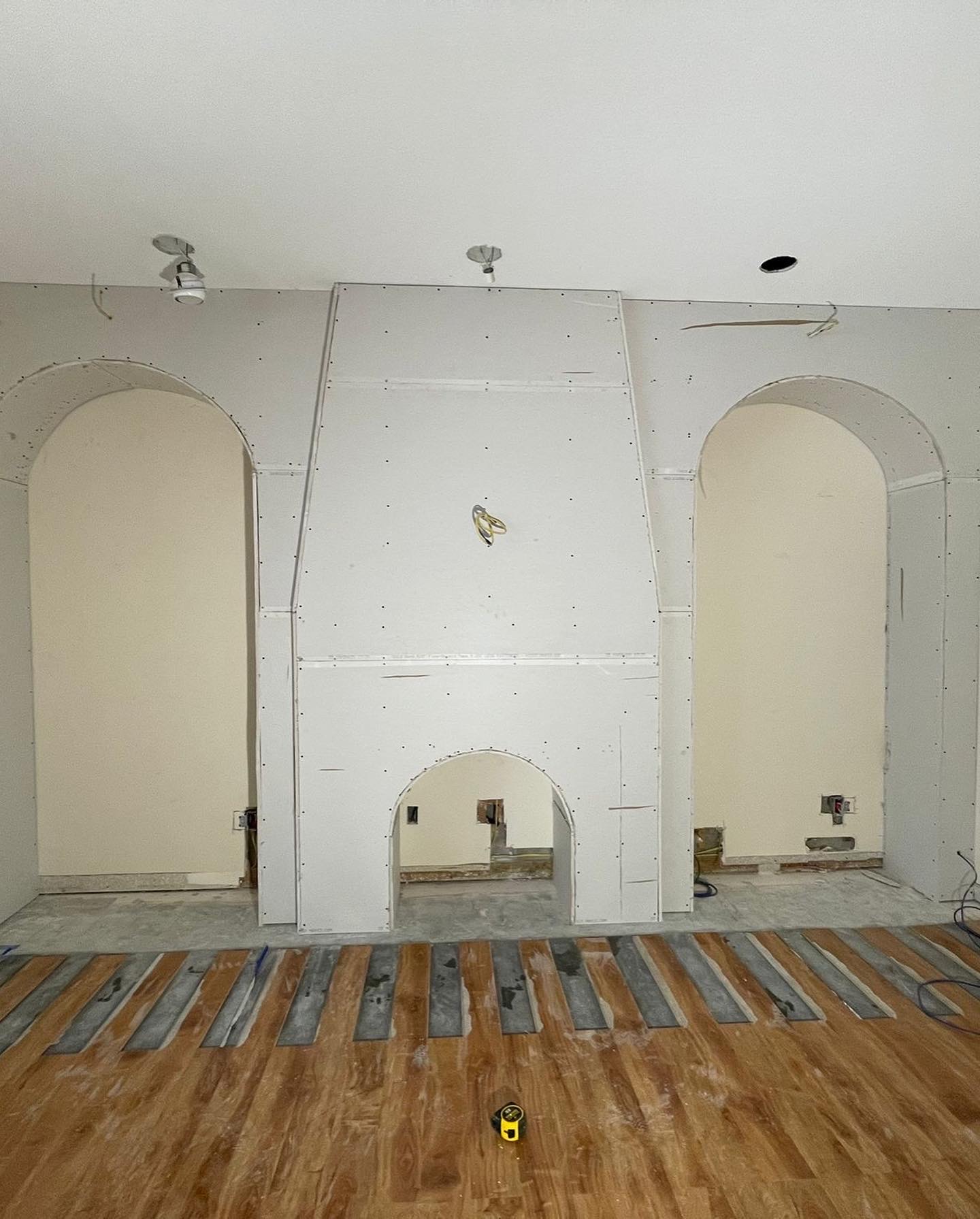 Completed drywall over custom steel-framed archways in residential remodel